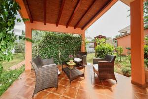 a patio with wicker chairs and a table at Apartments Cvek in Rovinj