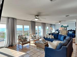a living room with a blue couch and chairs at Blue Heron in Pensacola Beach