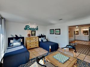 a room with a bedroom with a bed and a table at Blue Heron in Pensacola Beach +33 photos