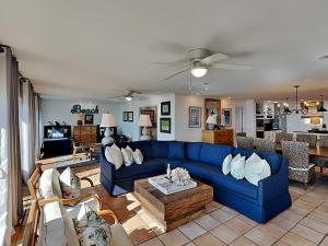 a living room with a blue couch and a table at Blue Heron in Pensacola Beach