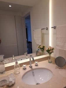 a bathroom with a sink and a large mirror at Legui Suites in Salta +20 photos