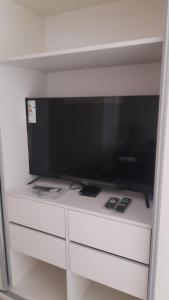 a flat screen tv sitting on top of a white dresser at Legui Suites in Salta