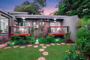 a house with a lawn in front of it at Honeysuckle in Tzaneen
