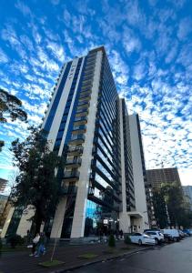 a tall building with cars parked in front of it at next apartment lux in Batumi