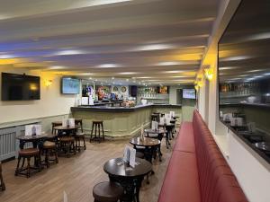 a restaurant with tables and chairs and a bar at The Famous Star Hotel Moffat in Moffat
