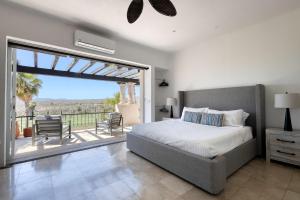 a bedroom with a bed and a balcony with a view at The Fairway Villa in San José del Cabo +38 photos