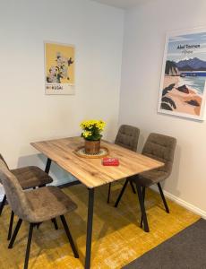 a dining room table with chairs and flowers on it at Nelson Escape in Nelson