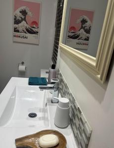 a white bathroom with a sink and a mirror at Nelson Escape in Nelson