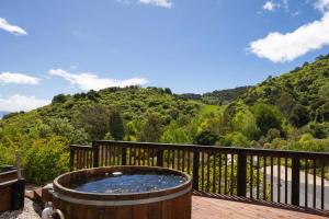a hot tub on a deck with a view of a mountain at Nelson Escape in Nelson