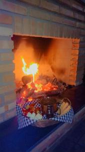 a brick oven with food cooking in it at Serra mineira in Resende +16 photos
