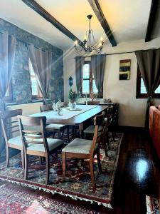 a dining room with a large table and chairs at ByDoukas Mountain Resort in Palaios Agios Athanasios