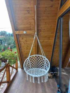 a swing on the porch of a house at Cabanele Avoca in Avrig