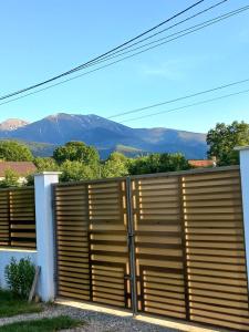 a wooden privacy fence with mountains in the background at Cabanele Avoca in Avrig