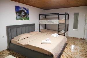 a bedroom with a bunk bed with two towels at Villa 2VB in Shkodër