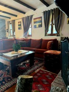 a living room with a couch and a table at ByDoukas Mountain Resort in Palaios Agios Athanasios