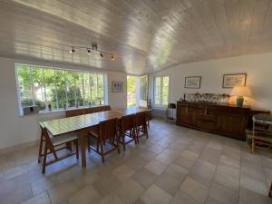 a large dining room with a table and chairs at La Villa du Clocher in Saint-Clément-des-Baleines