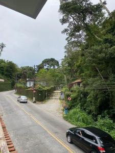 a car parked on the side of a road at M&M Pousada in Petrópolis