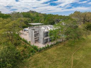 an aerial view of a house in the woods at Nelblu Flamingo Suites in Playa Flamingo