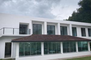 a white house with a brown roof at M&M Pousada in Petrópolis