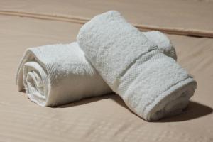 a white roll of toilet paper sitting on a bed at Villa 2VB in Shkodër +72 photos