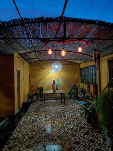 an outdoor patio with a table and a ceiling with lights at Alojamiento San Nicolas in La Rioja