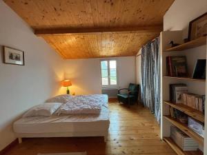 a bedroom with a bed and a wooden ceiling at La Villa de la Digue in Saint-Clément-des-Baleines +11 photos