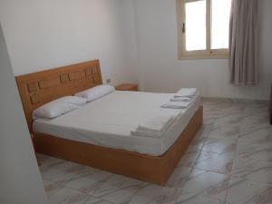 a bedroom with a large bed with white sheets and a window at Sea simple haven in Sharm El Sheikh +27 photos