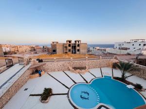 a view from the roof of a building with a swimming pool at Sea simple haven in Sharm El Sheikh