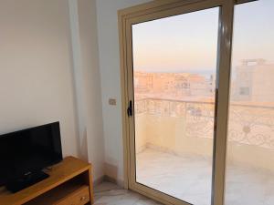 a sliding glass door with a view of a balcony at Sea simple haven in Sharm El Sheikh