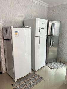 two refrigerators sitting next to each other in a room at Cada da lanny in Camaçari
