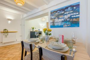 a dining room with a table with chairs and a painting at 2 Bed in Wadebridge oc-m32567 in Wadebridge +23 photos