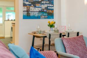 a dining room with a table and chairs and a painting at 2 Bed in Wadebridge oc-m32567 in Wadebridge