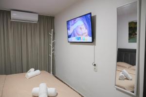 a bedroom with a mirror and a tv on the wall at Villa 2VB in Shkodër