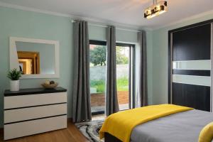 a bedroom with a bed and a large window at Villa Vieira Ocean View in Gaula