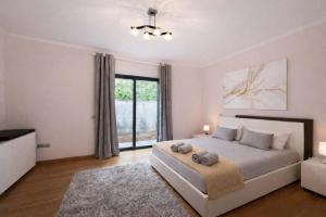 a bedroom with a bed and a large window at Villa Vieira Ocean View in Gaula