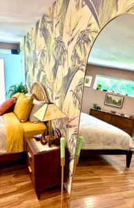 a bedroom with a bed and a large mirror at The Railyard NOLA - Adult Only, Clothing Optional Pool in New Orleans