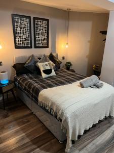a bedroom with a large bed with pillows on it at Modern spacious Belfast city stay free parking in Belfast