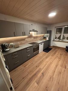 a large kitchen with wooden floors and a counter top at Ferienwohnung Klosterblick in Bastheim