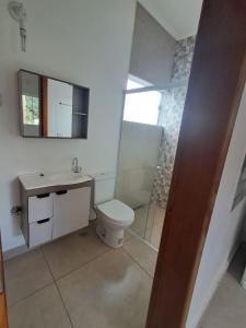 a bathroom with a toilet and a sink and a shower at Recanto das Violetas in Extrema