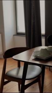 a table and chairs with a plate on top of it at La Tour Grégoire in Clermont-Ferrand +35 photos