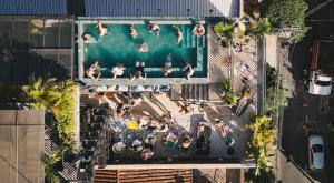 an overhead view of people at a swimming pool at Los Patios Hostel Medellin in Medellín