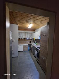 a kitchen with white appliances and a large open door at Zimmer zu vermieten in Rammingen