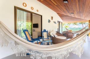 a hammock in the living room of a villa at Chales Maragogi in Maragogi