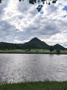 a large body of water with mountains in the background at Cabaña Valle del alma in Nono