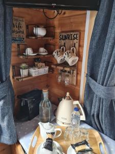 a room with a table with a tea pot and a tea kettle at Weston's Wood Cabins in Blakeney +12 photos