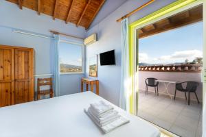 a bedroom with a bed and a balcony at Summer House Louisa in Lygia