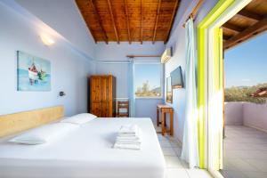 a bedroom with a bed and a large window at Summer House Louisa in Lygia