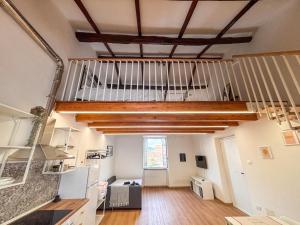 a large kitchen with wooden floors and ceilings at CAERE RoGi House in Cerveteri