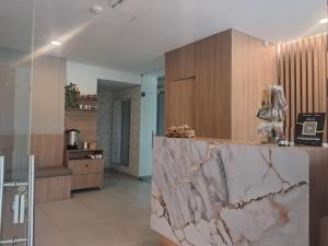 a lobby with a marble counter and wooden cabinets at Hotel ECO 44 in Medellín