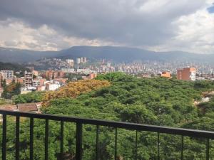 a view of a city from a balcony at Hotel ECO 44 in Medellín